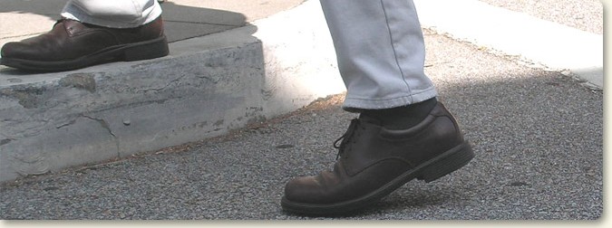 a pedestrian stepping on to the curb
