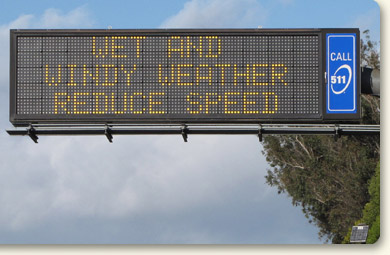 Photo of changeable message sign: Wet and windy weather, reduce speed
